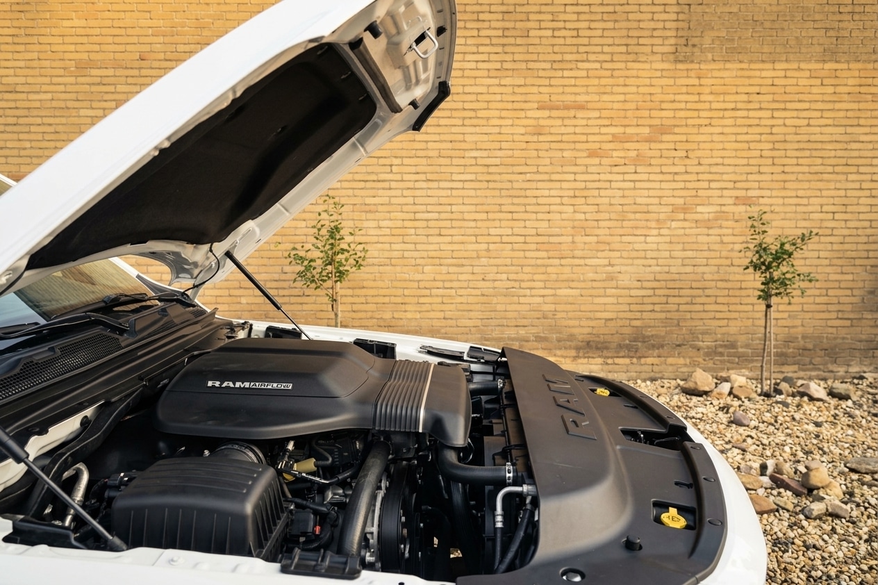 Geopende motorkap van de witte Dodge RAM 1500 trouwauto met zicht op de motor